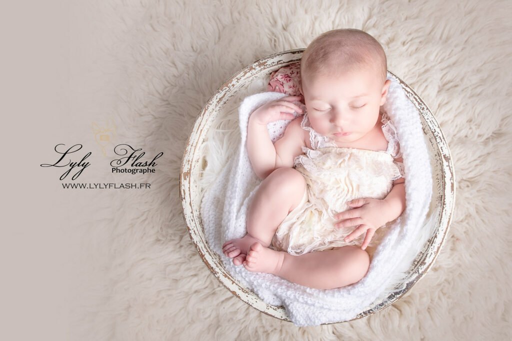a baby sleeping in a bowl