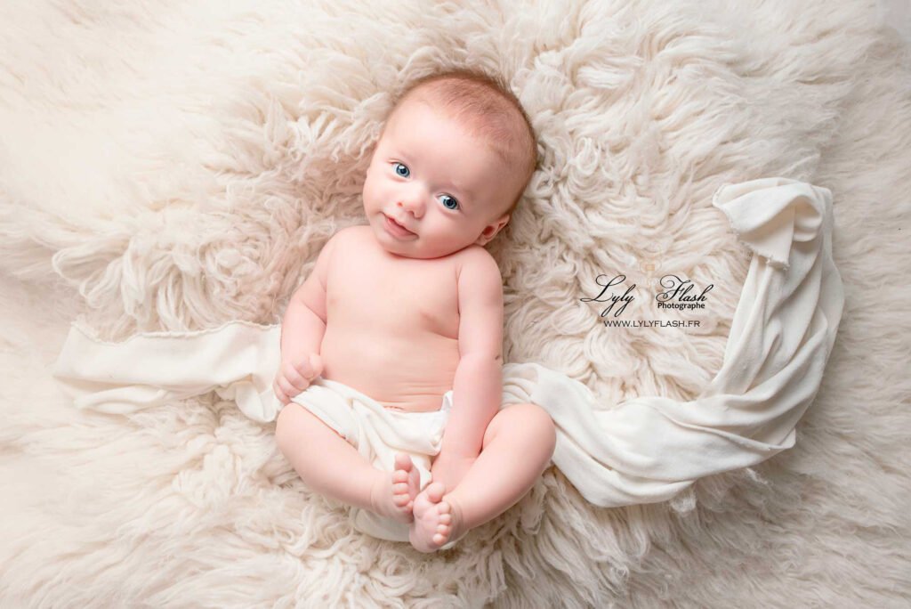 a baby lying on a blanket