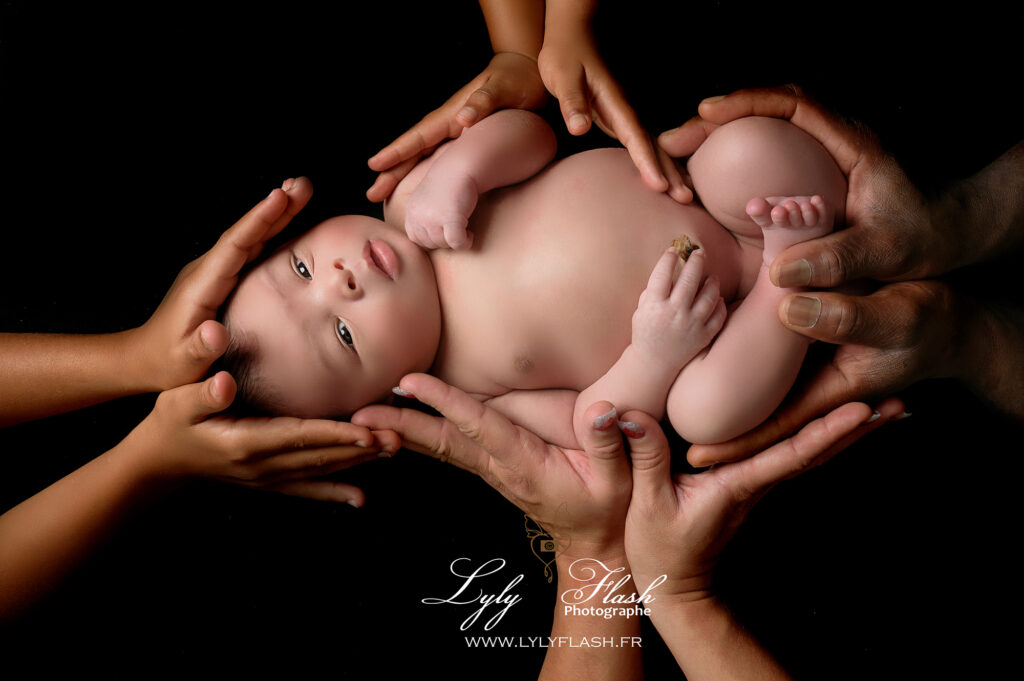 un bébé est porté par toutes les mains de sa famille photo symbolique
