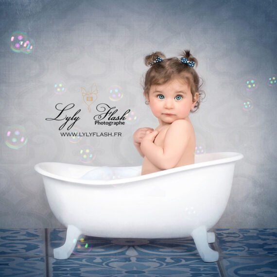 photo d une petite fille qui prend un bain de bulle pour son smash the bath sur Brignoles. La petite fille de 12 mois prend la pose comme une véritable star de cinéma