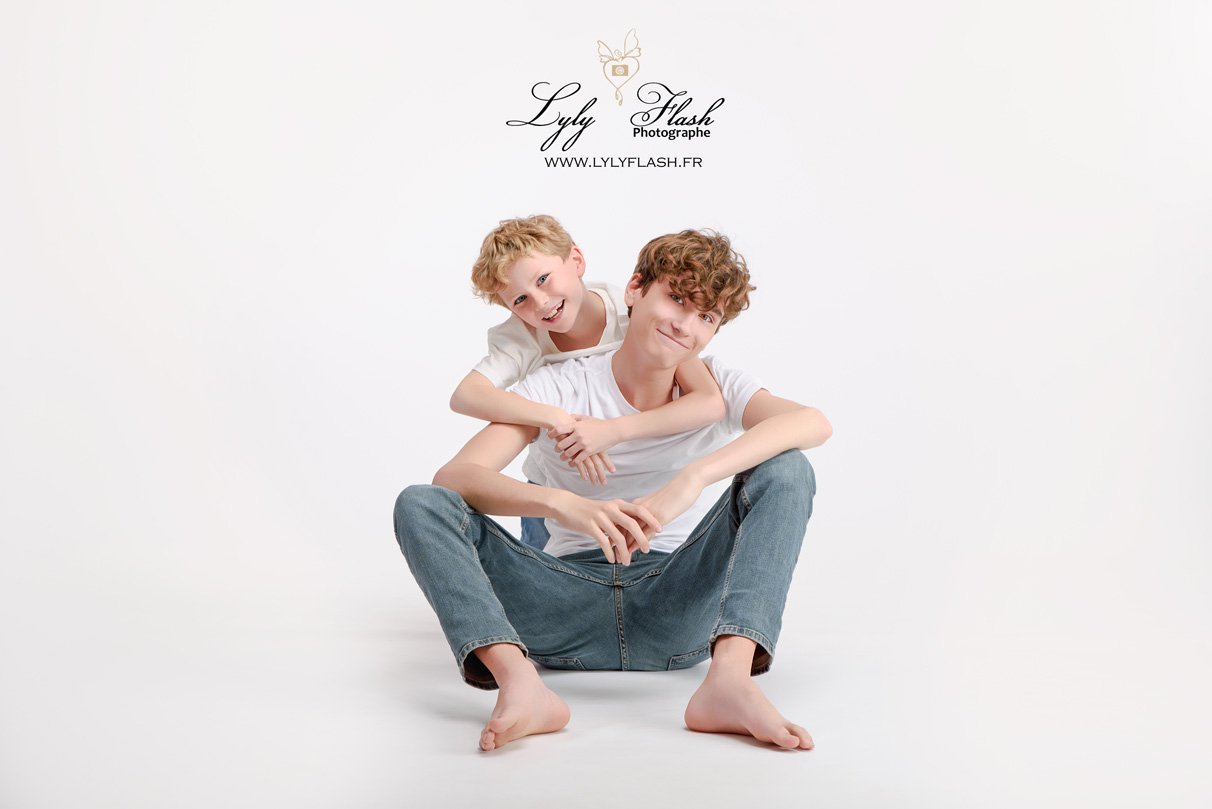 Famille souriante avec leur adolescent durant une séance photo complice au studio